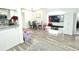 Living area offers an entertainment center with a large TV, dining space, and updated kitchen at 2525 W Bay Dr # A20, Belleair Bluffs, FL 33770