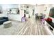 Bright living room boasts wood-look floors, neutral tones, modern furnishings, and an open-concept design at 2525 W Bay Dr # A20, Belleair Bluffs, FL 33770
