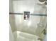 Tiled shower stall with built-in shelving for toiletries at 2525 W Bay Dr # A20, Belleair Bluffs, FL 33770