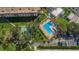 Aerial view showcasing the pool and shuffleboard court, surrounded by lush greenery and convenient parking at 2700 Bayshore Blvd # 547, Dunedin, FL 34698