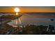 Panoramic aerial view of the community showcasing waterfront access, lush greenery, and stunning sunset scenery at 2700 Bayshore Blvd # 547, Dunedin, FL 34698