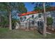 Exterior view of the property showcasing a private patio and lush green lawn at 2700 Bayshore Blvd # 547, Dunedin, FL 34698