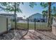View of backyard with patio, black iron fence, and view of the community parking at 2700 Bayshore Blvd # 547, Dunedin, FL 34698