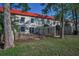 Fenced backyard featuring a well-maintained lawn, patio, and landscaping at 2700 Bayshore Blvd # 547, Dunedin, FL 34698