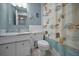 Well-lit bathroom with a mirror, seashell themed shower curtain, and white cabinets at 2700 Bayshore Blvd # 547, Dunedin, FL 34698