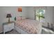 Cozy bedroom features a queen bed with beach-themed comforter and decor, plus a bright window view at 2700 Bayshore Blvd # 547, Dunedin, FL 34698