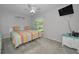 Bright bedroom features a TV, ceiling fan, and a colorful bedspread in a home setting at 2700 Bayshore Blvd # 547, Dunedin, FL 34698