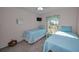 Bright bedroom showcasing two twin beds, a window view, and modern decor at 2700 Bayshore Blvd # 547, Dunedin, FL 34698