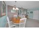Open dining area featuring a wood table, white chairs, and a glimpse of the kitchen at 2700 Bayshore Blvd # 547, Dunedin, FL 34698