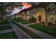 Exterior view of multiple townhomes featuring sidewalks and lush landscaping at sunset at 2700 Bayshore Blvd # 547, Dunedin, FL 34698