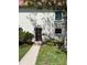 Charming home with a black front door and an upstairs window, complemented by vibrant landscaping at 2700 Bayshore Blvd # 547, Dunedin, FL 34698