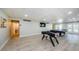 Well-lit game room showcasing a foosball table, pool table, and laminate floors for entertainment at 2700 Bayshore Blvd # 547, Dunedin, FL 34698