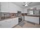 Well-lit kitchen with white cabinetry, stainless steel appliances, and neutral granite countertops at 2700 Bayshore Blvd # 547, Dunedin, FL 34698