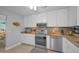 Bright kitchen with stainless steel appliances, granite counters, and modern lighting at 2700 Bayshore Blvd # 547, Dunedin, FL 34698