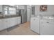 Functional laundry area combined with kitchen, featuring a stainless steel refrigerator and modern appliances at 2700 Bayshore Blvd # 547, Dunedin, FL 34698