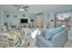 Bright, beach-themed living room with comfortable seating, ceiling fan, and access to outdoor area at 2700 Bayshore Blvd # 547, Dunedin, FL 34698
