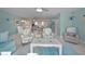 Open-concept living area featuring beach-themed decor, comfortable seating, and bright, airy space at 2700 Bayshore Blvd # 547, Dunedin, FL 34698