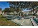 Community shuffleboard court surrounded by benches and lush trees at 2700 Bayshore Blvd # 547, Dunedin, FL 34698