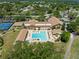 Aerial view of the community pool with lounge chairs and tables for community members to relax at 2735 Sherbrooke Ln # D, Palm Harbor, FL 34684