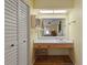 Bathroom area featuring vanity with a sink, storage cabinets, lighting, and mirror at 2735 Sherbrooke Ln # D, Palm Harbor, FL 34684