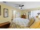 Cozy bedroom featuring a ceiling fan, natural light, and access to the outside at 2735 Sherbrooke Ln # D, Palm Harbor, FL 34684