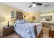 Comfortable bedroom with ceiling fan, wood floors, bedside tables and natural light at 2735 Sherbrooke Ln # D, Palm Harbor, FL 34684