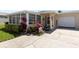 Charming single-story home with well-manicured landscaping, mature trees, and an attached one car garage at 2735 Sherbrooke Ln # D, Palm Harbor, FL 34684