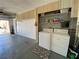 Functional garage space with washer, dryer, storage cabinets and access to the outdoors at 2735 Sherbrooke Ln # D, Palm Harbor, FL 34684