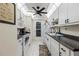 Bright kitchen featuring white appliances, ample cabinet space, and tile flooring for easy maintenance at 2735 Sherbrooke Ln # D, Palm Harbor, FL 34684