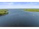 Aerial view of lake and shoreline with lush green trees at 2735 Sherbrooke Ln # D, Palm Harbor, FL 34684