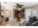 Cozy living room with hardwood floors, comfortable seating, ceiling fan and access to enclosed porch at 2735 Sherbrooke Ln # D, Palm Harbor, FL 34684