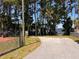 Paved parking area along lake with bench and mature trees at 2735 Sherbrooke Ln # D, Palm Harbor, FL 34684