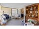 Bright sunroom with a variety of seating options, natural light, and vintage furniture at 2735 Sherbrooke Ln # D, Palm Harbor, FL 34684