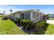 A sunroom with awning windows and a view of the landscaped yard provides relaxation and natural light at 2735 Sherbrooke Ln # D, Palm Harbor, FL 34684