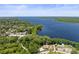 Scenic aerial view of a large lake with lush trees surrounding the community at 2735 Sherbrooke Ln # D, Palm Harbor, FL 34684