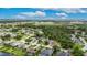 Panoramic aerial view of a residential area with beautiful homes, green spaces, and a tranquil lake surrounded by trees at 3004 Spring Hammock Dr, Plant City, FL 33566