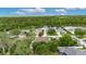This aerial view shows a home situated in a peaceful neighborhood close to a scenic lake and natural surroundings at 3004 Spring Hammock Dr, Plant City, FL 33566