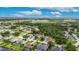 Aerial shot of the home located in a neighborhood with well-maintained lawns and surrounding farmland at 3004 Spring Hammock Dr, Plant City, FL 33566
