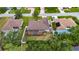 This aerial view showcases a home with a screened lanai and well-maintained lawn in a quiet, residential neighborhood at 3004 Spring Hammock Dr, Plant City, FL 33566