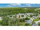 Wide aerial shot showcasing home in a quiet residential community with trees and a pond nearby at 3004 Spring Hammock Dr, Plant City, FL 33566