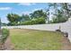 Well-maintained backyard featuring lush green grass and a white fence, providing privacy and a safe play area at 3004 Spring Hammock Dr, Plant City, FL 33566