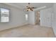 Bright bedroom with a ceiling fan, two windows, and a neutral color scheme at 3004 Spring Hammock Dr, Plant City, FL 33566