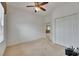 This bedroom boasts a ceiling fan, carpet floors, a large closet, and neutral-toned walls at 3004 Spring Hammock Dr, Plant City, FL 33566