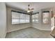 Tile-floored dining area with plentiful natural light provided through large windows and a ceiling fan at 3004 Spring Hammock Dr, Plant City, FL 33566