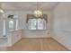 The dining area features neutral carpet and is illuminated by an elegant chandelier at 3004 Spring Hammock Dr, Plant City, FL 33566