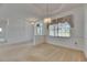 Formal dining room with carpet flooring, chandelier lighting, and large window at 3004 Spring Hammock Dr, Plant City, FL 33566