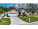 Charming single-story home with a two-car garage and a well-maintained front yard in a peaceful neighborhood at 3004 Spring Hammock Dr, Plant City, FL 33566