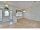 Inviting foyer leading to a bright, carpeted living area, showcasing a stylish front door and elegant lighting at 3004 Spring Hammock Dr, Plant City, FL 33566