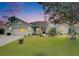 Charming single-story home with well-maintained landscaping and inviting curb appeal on a cloudy day at 3004 Spring Hammock Dr, Plant City, FL 33566