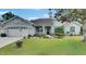 Charming single-story home with well-maintained landscaping and inviting curb appeal on a sunny day at 3004 Spring Hammock Dr, Plant City, FL 33566